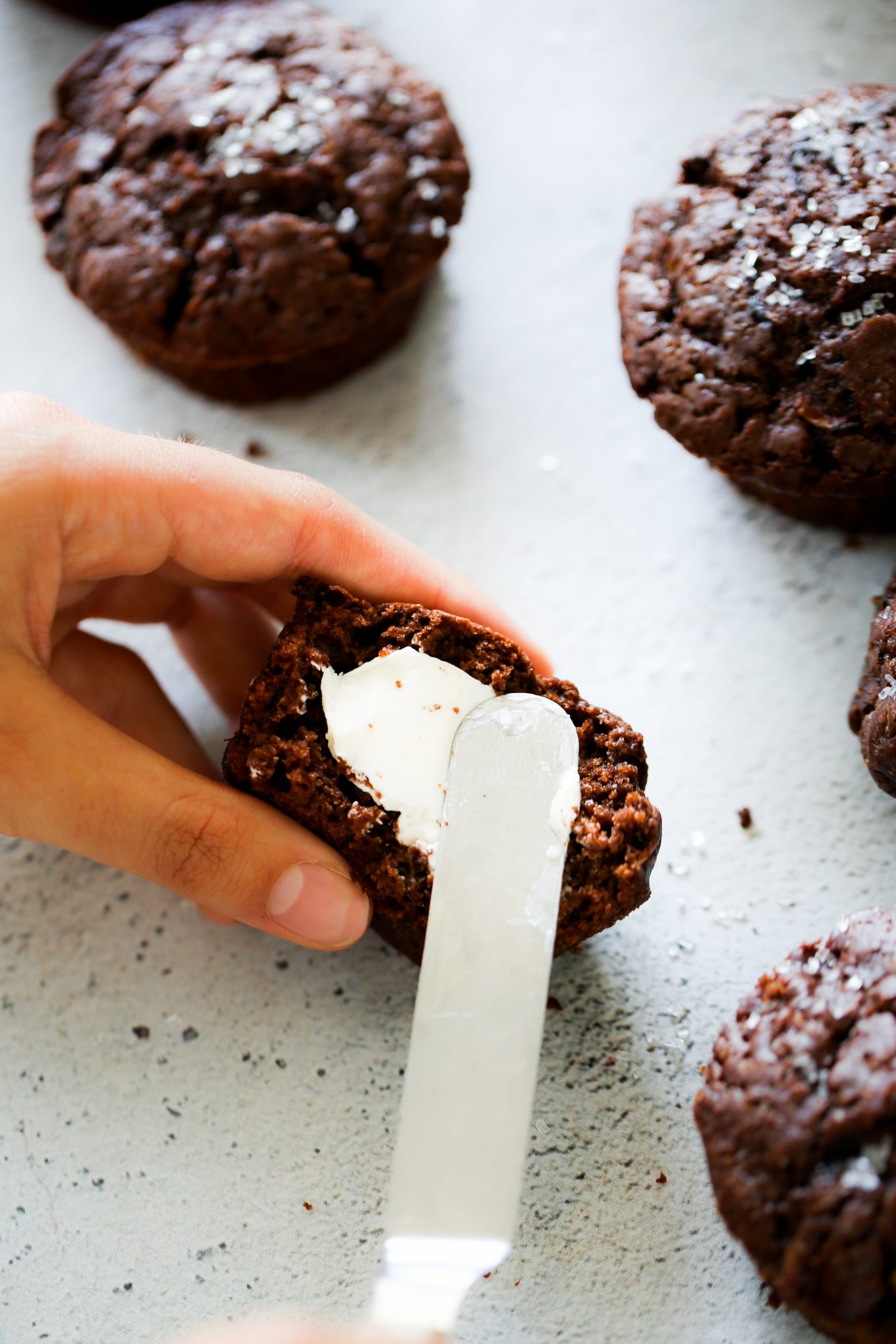 spreading vegan butter to the muffin