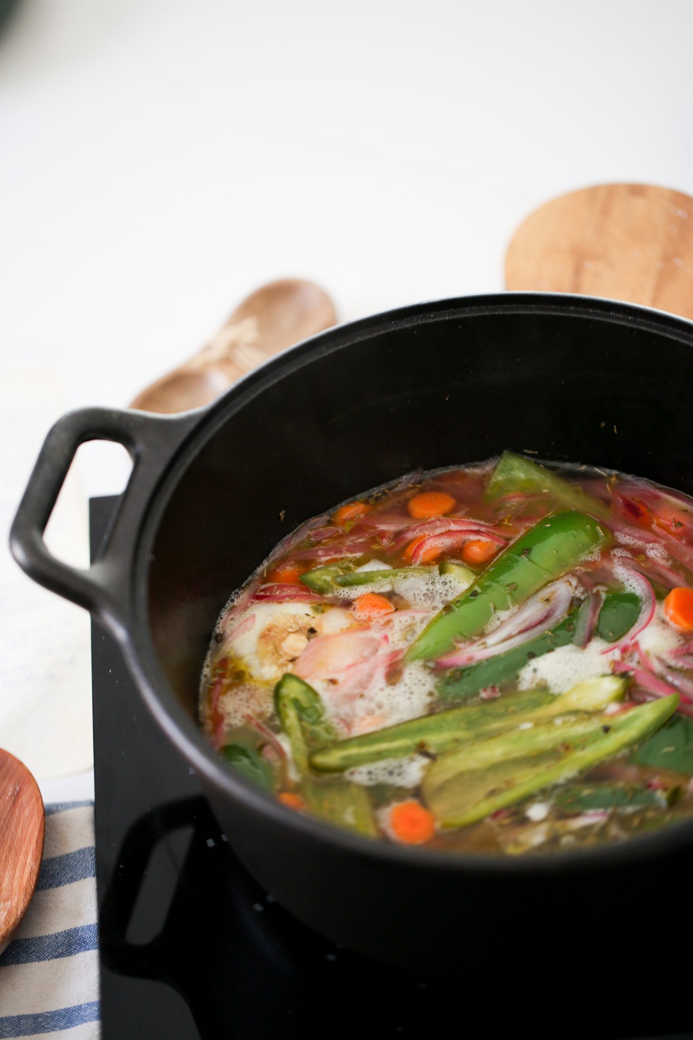 jalapeños, carrots, onions and garlic in a cast iron pot