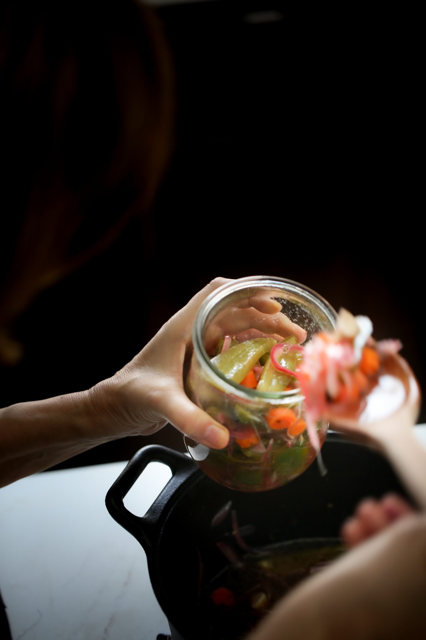 Storing the pickled jalapeños in a jar