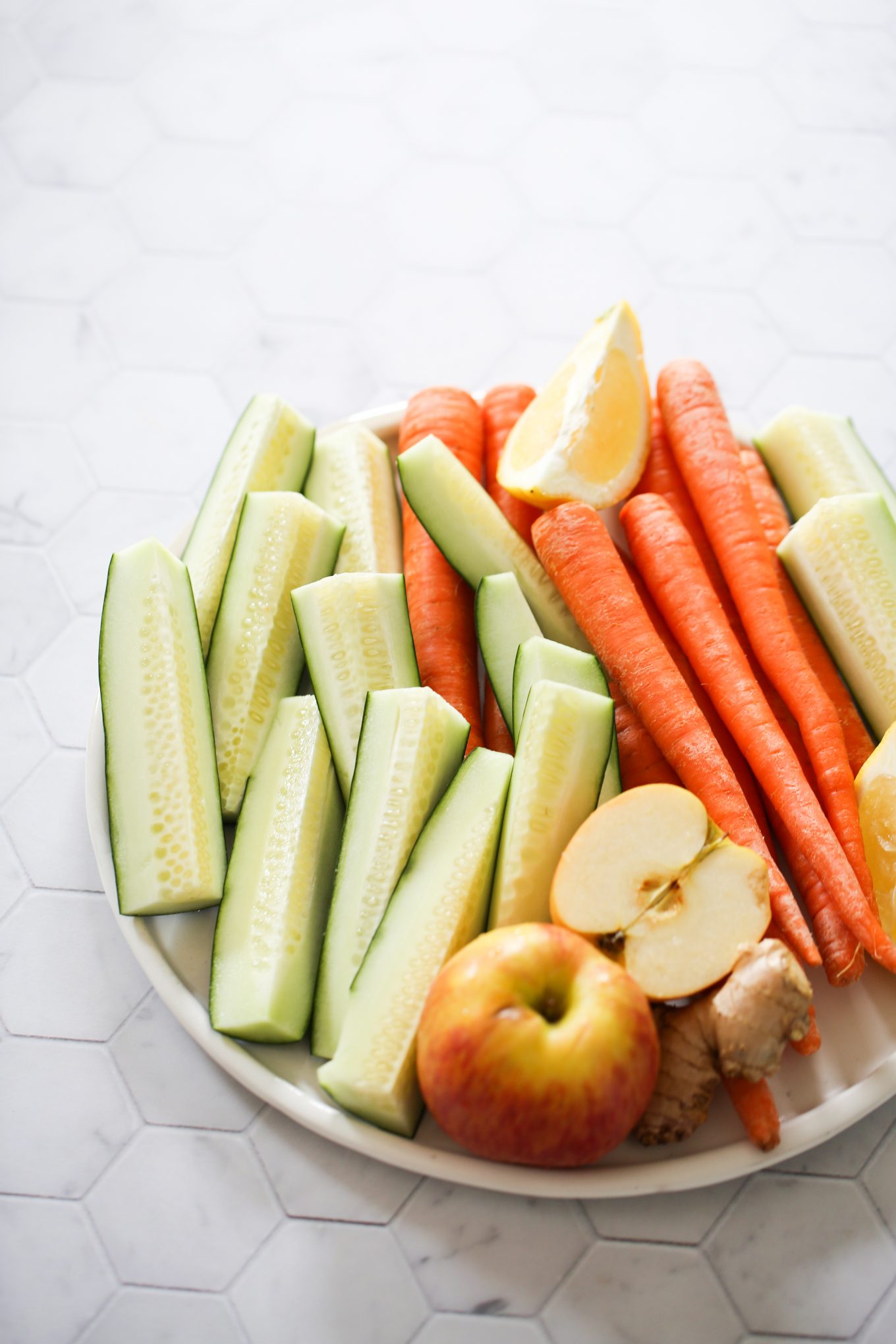 cucumber, apples, ginger, carrots and limes all sliced and ready to make juice.