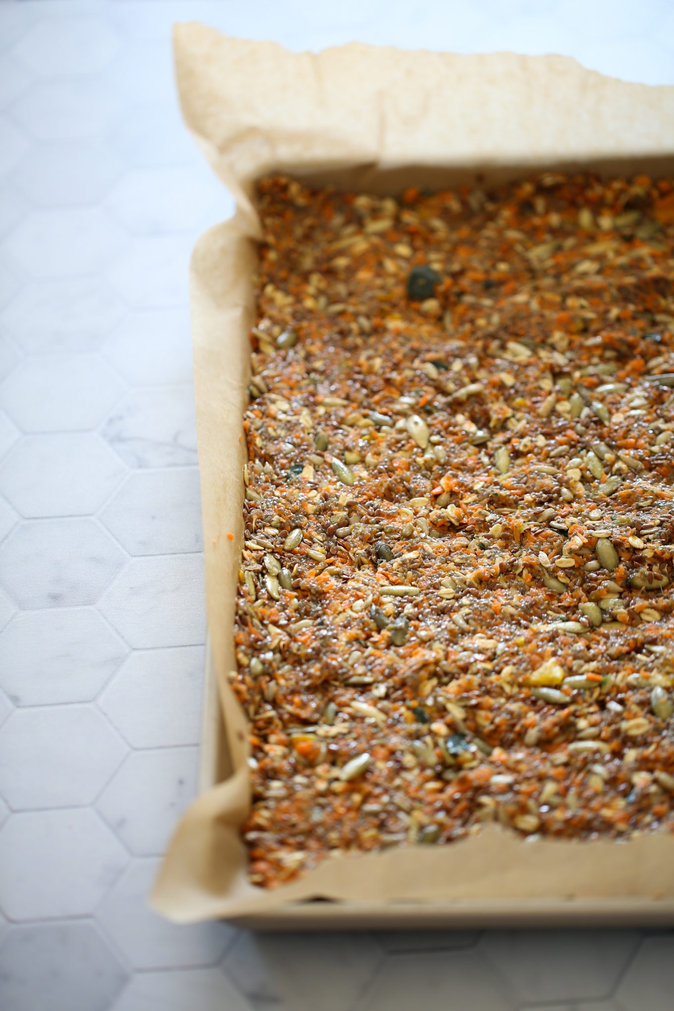 carrot juice crackers on a baking sheet before putting them in the oven