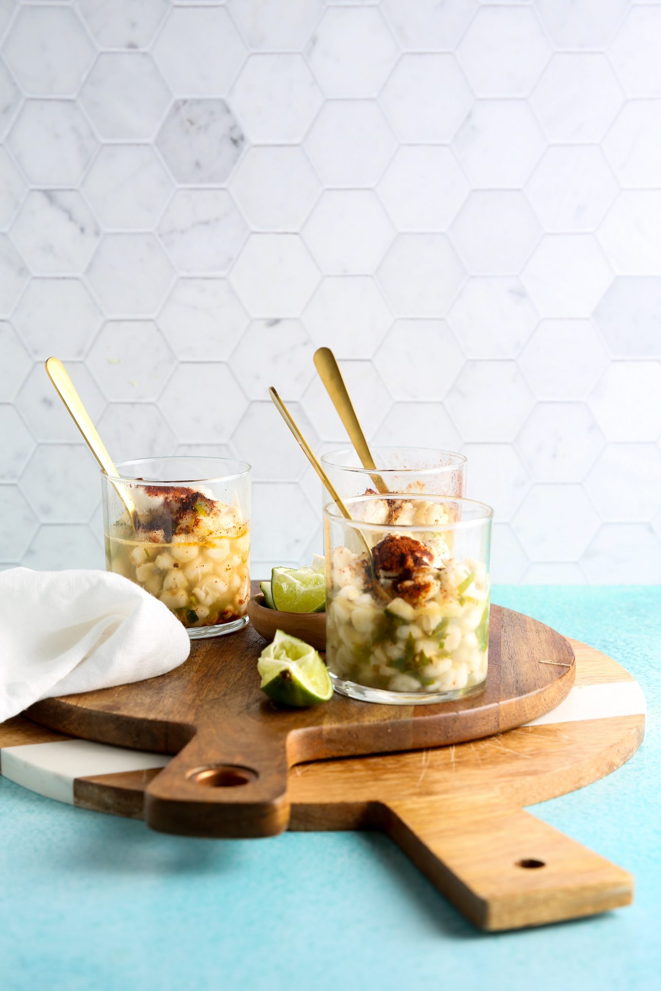 three cglass cups with esquites