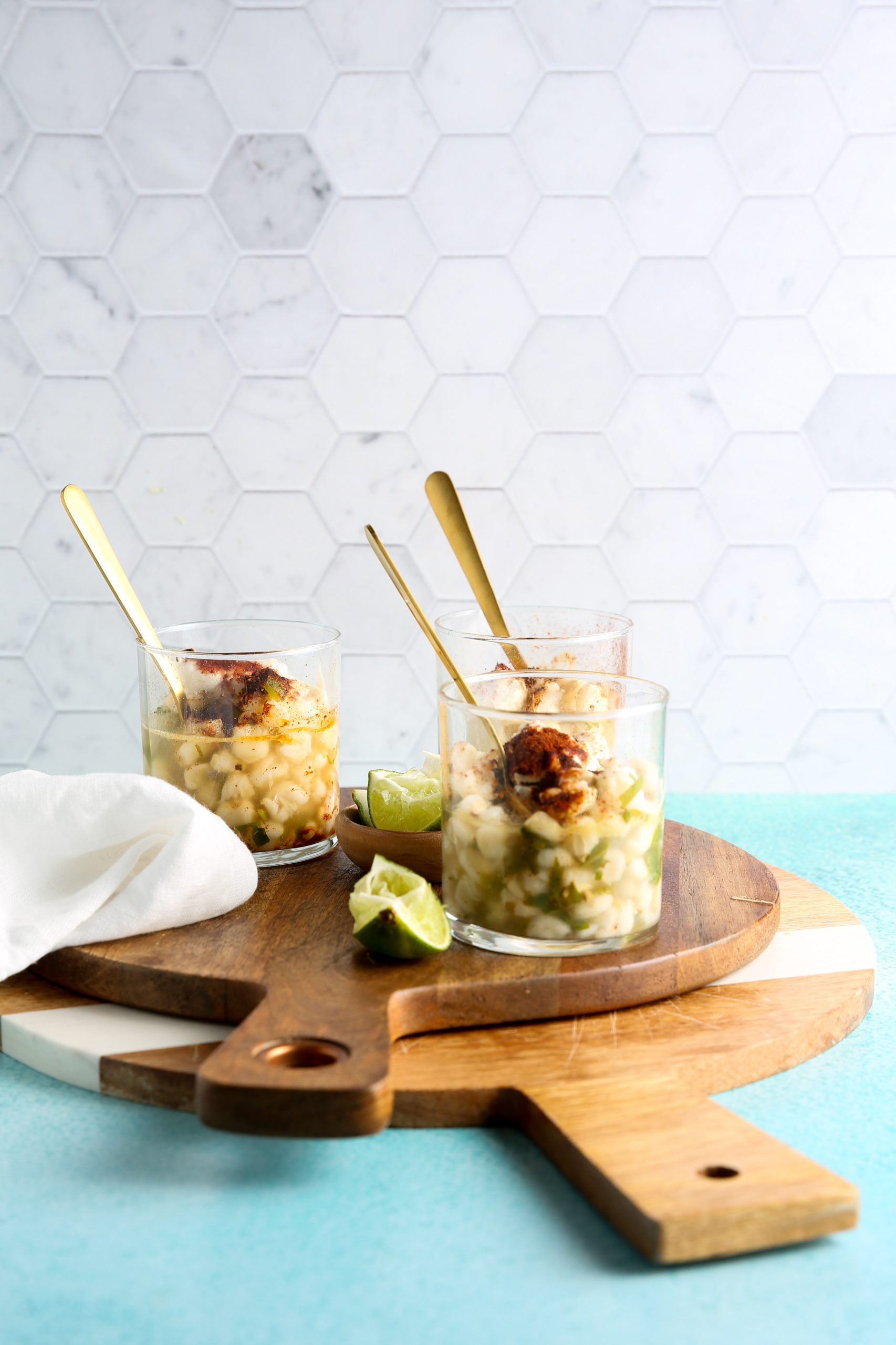three cglass cups with esquites