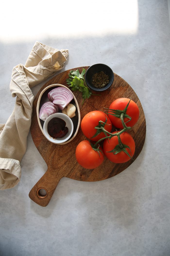 Tomato, onion, garlic and spices to make tomato chipotle broth for albondigas.