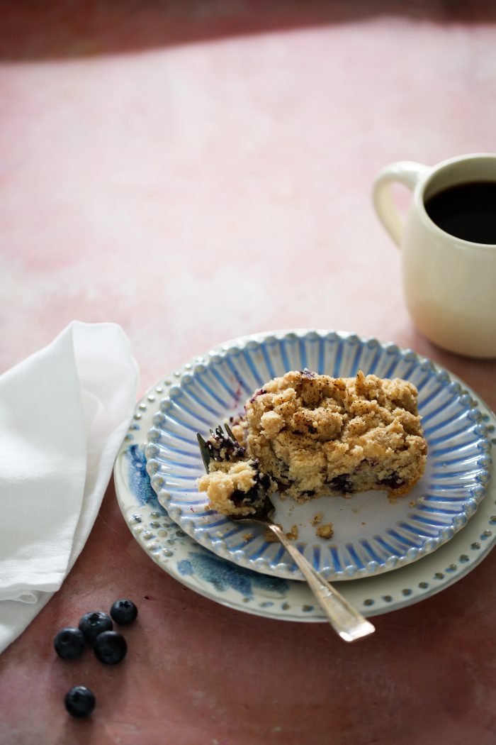 Blueberry vegan coffee cake on a blue plate.