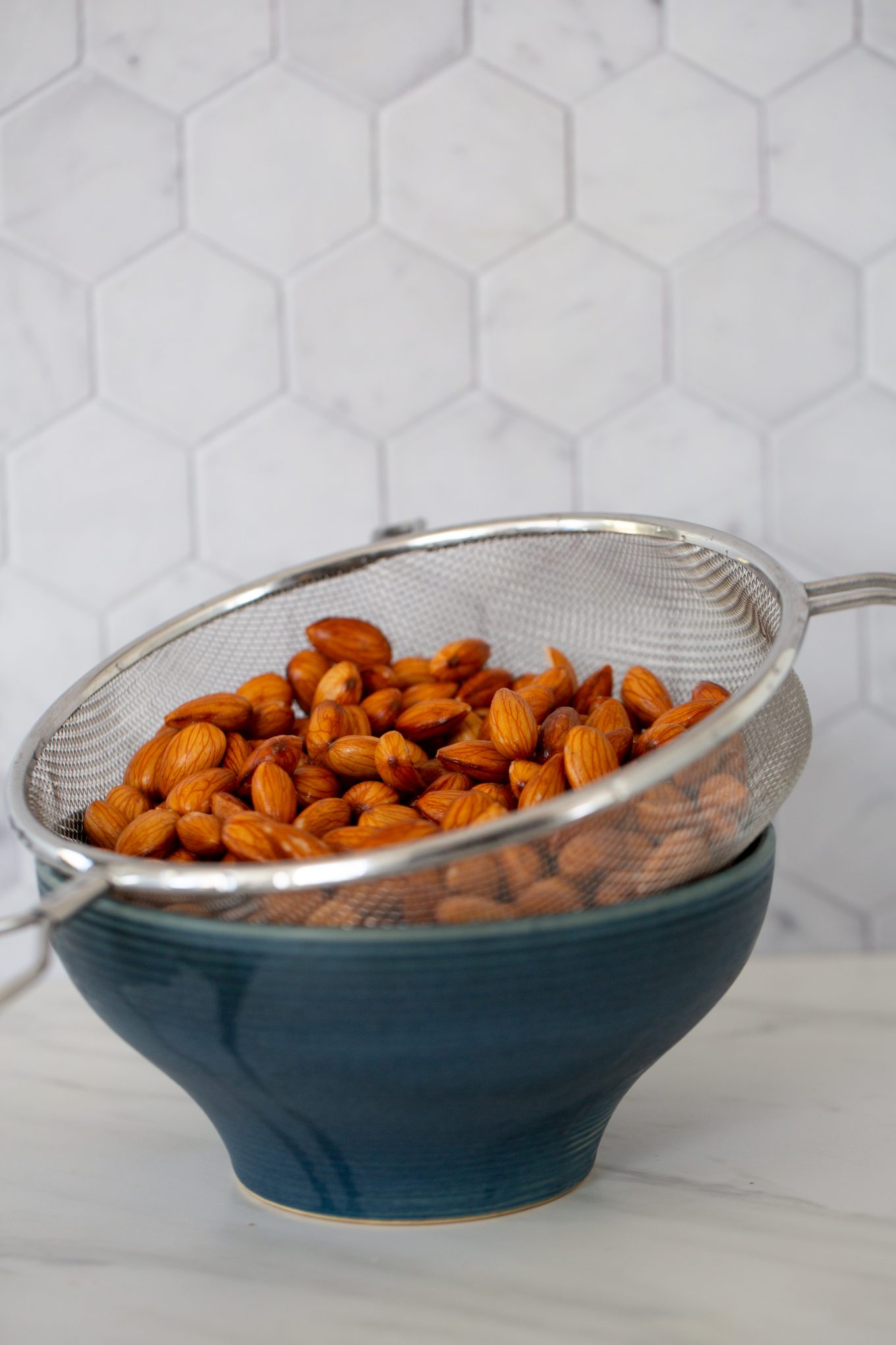 strained almonds in. astrainer