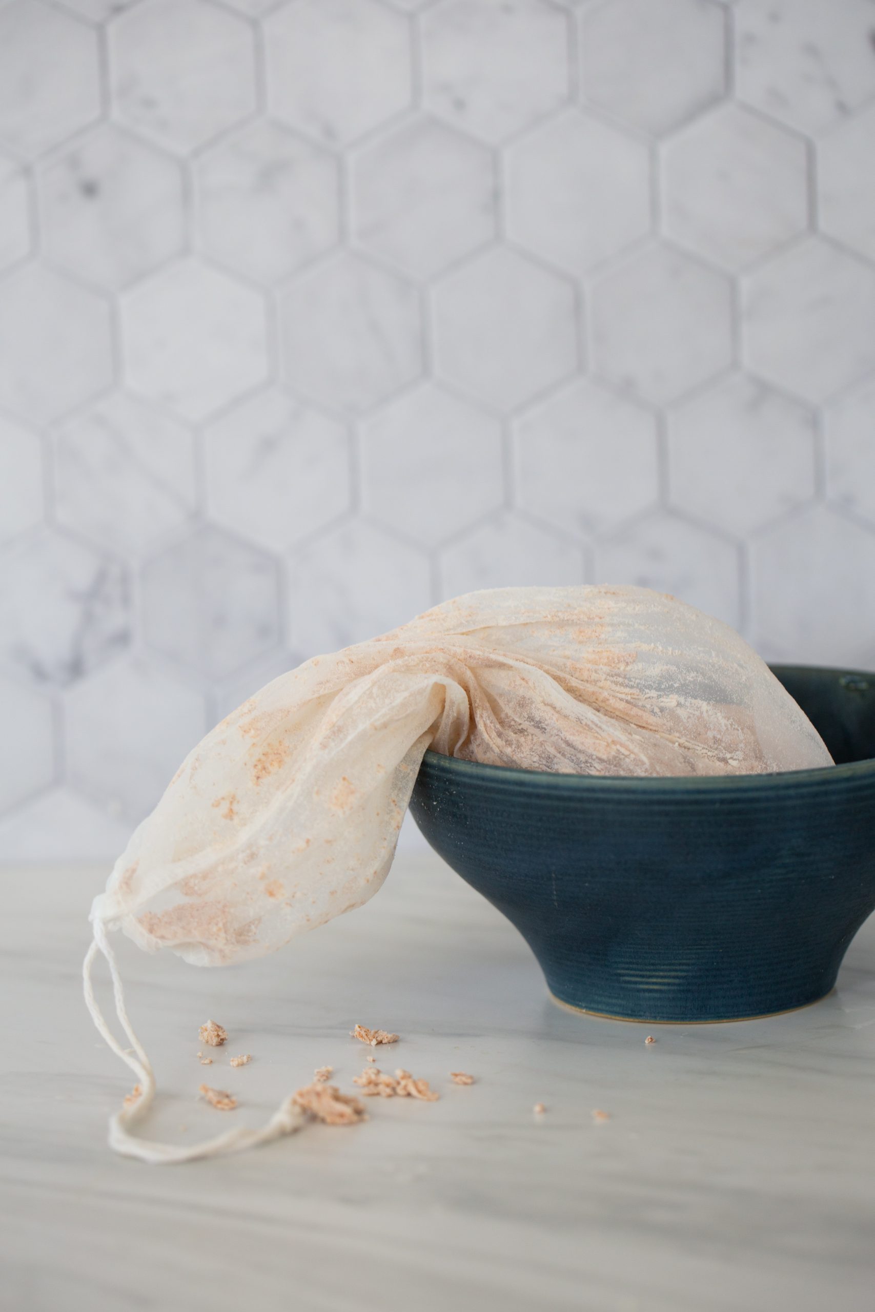 Almond pulp left in a nut milk bag after straining