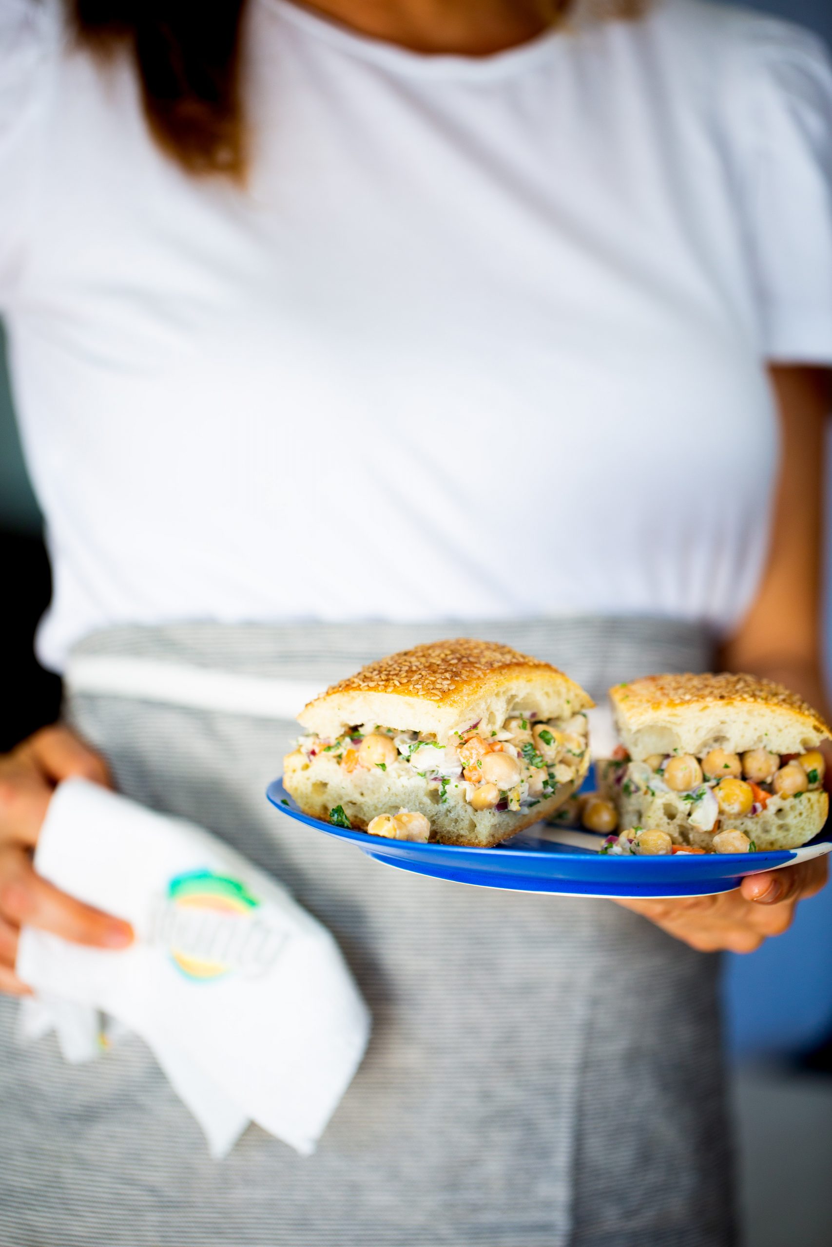 Chickpea salad Sandwich on a blue plate.
