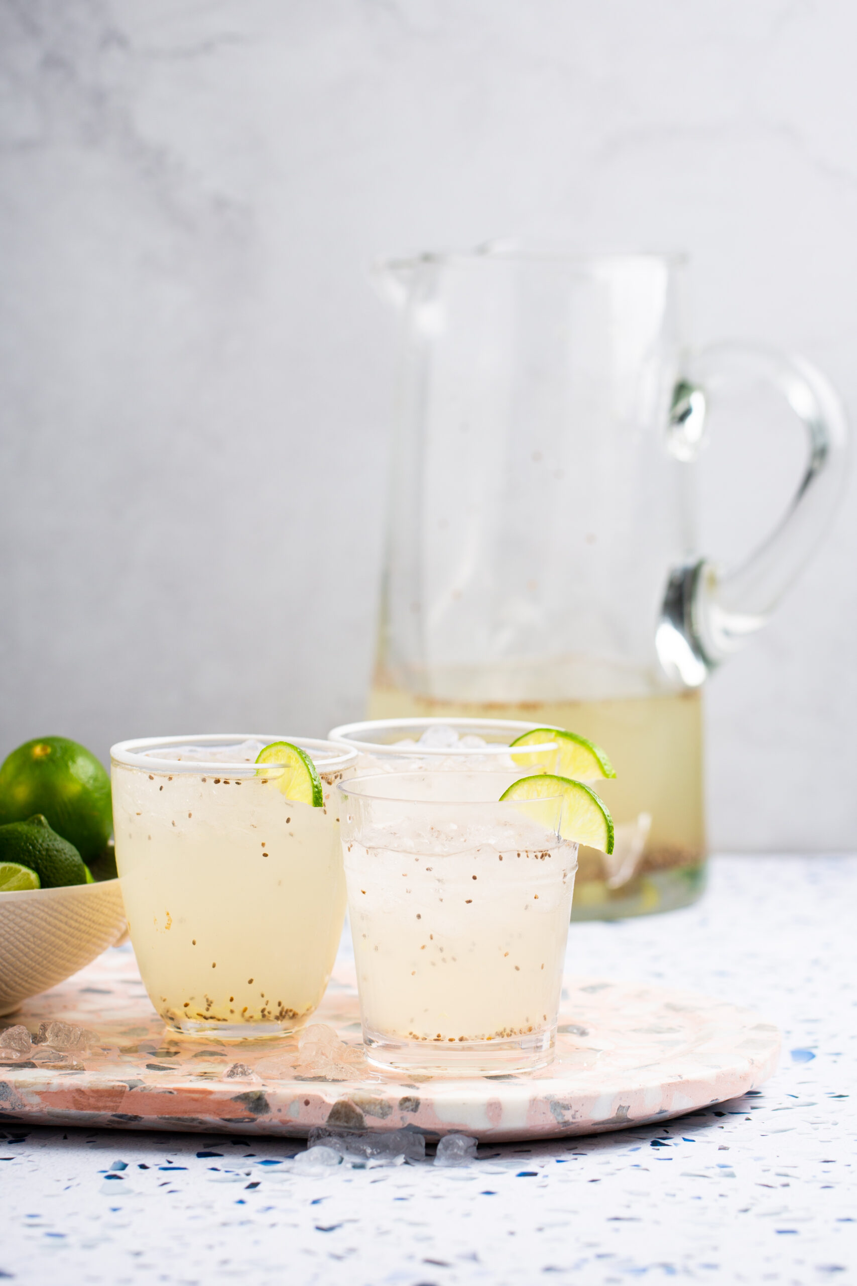 a pitcher and three glasses of chia limeade