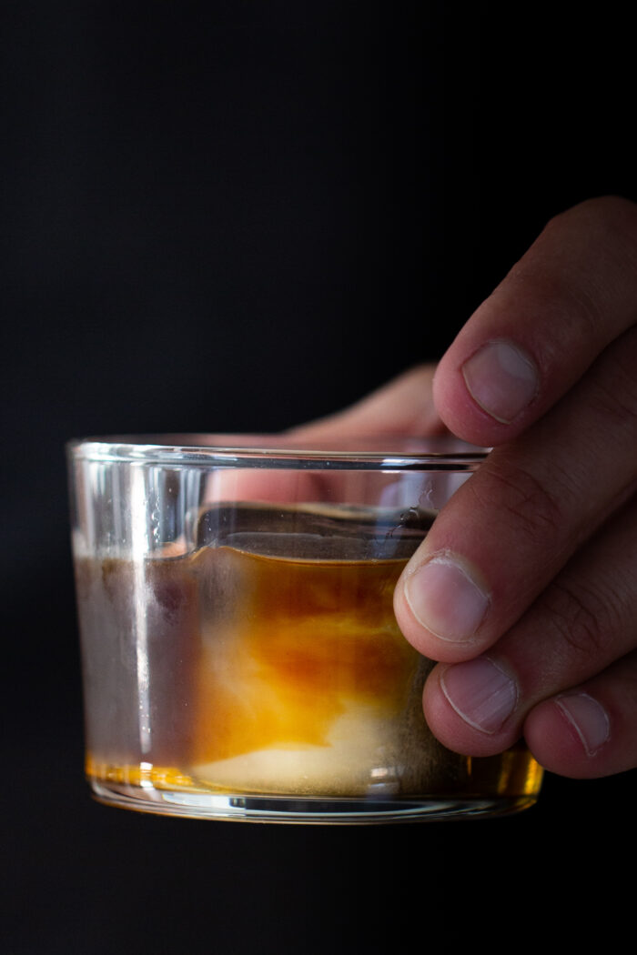 Carajillo, mexican coffee cocktail held by a man