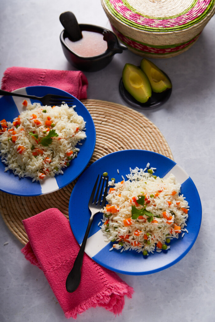 Mexican white rice, arroz blanco, served on blue dishes.