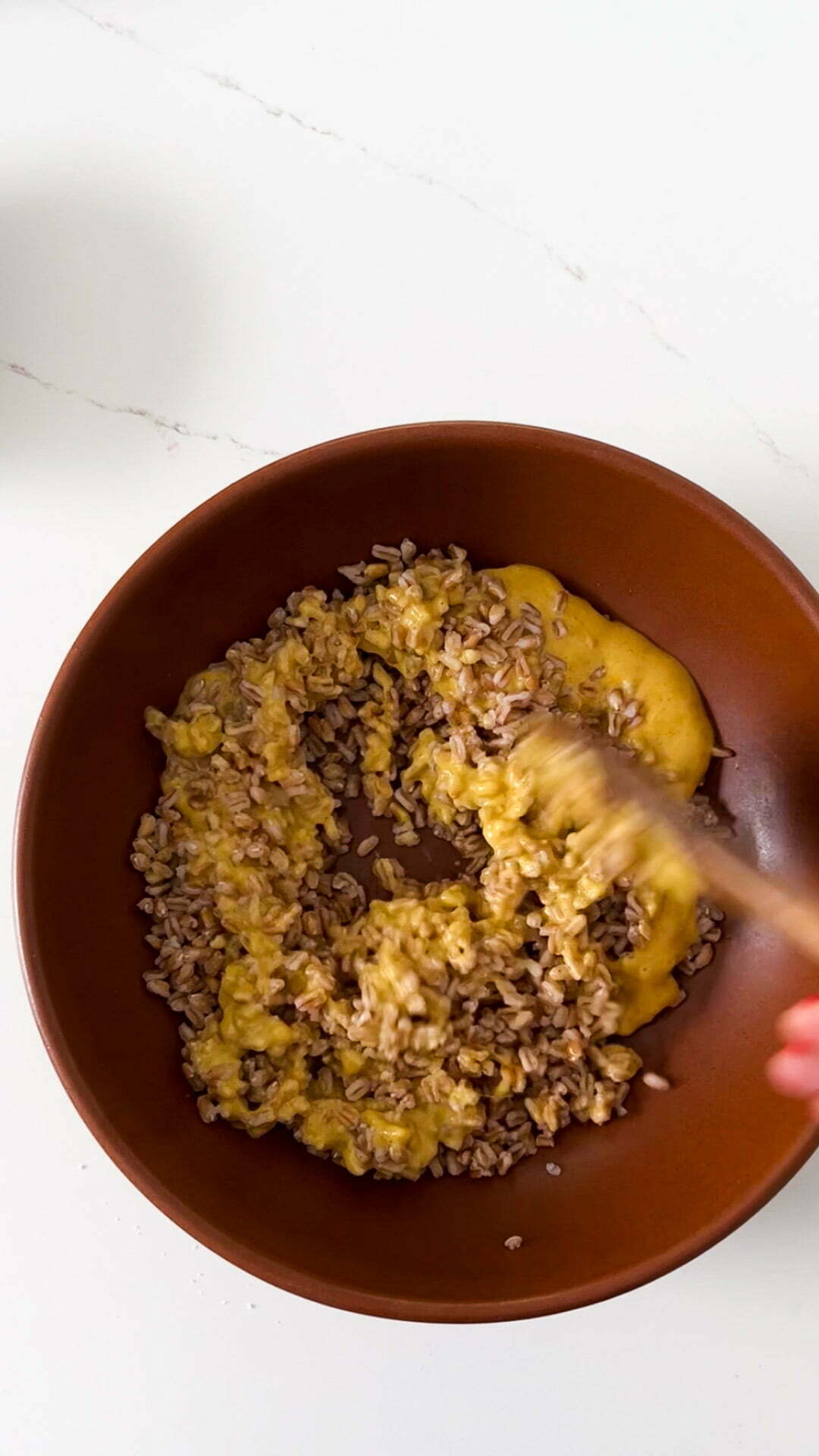 mixing farro grains with curry dressing