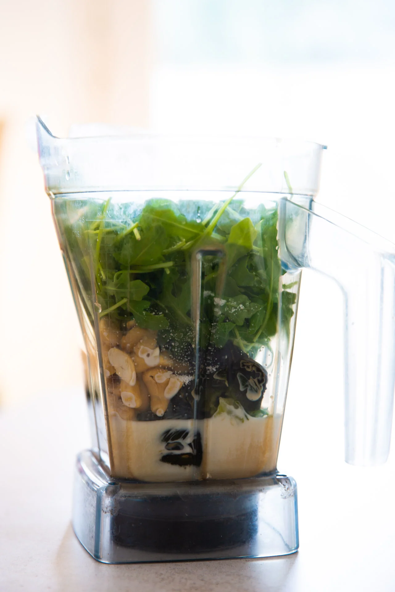 greens, cashews and poblano pepers in the blender