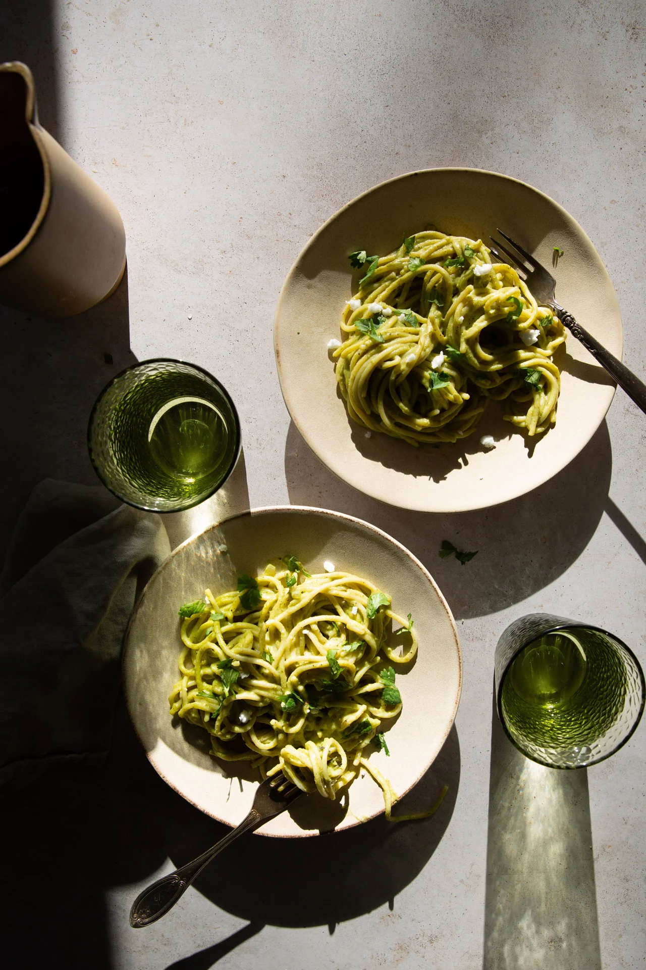 two dishes with espagueti verde, mexican green pasta