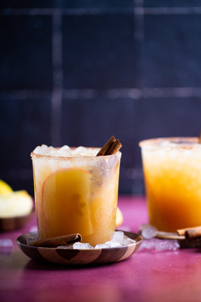 a apir of mezcal apple cider cocktails.