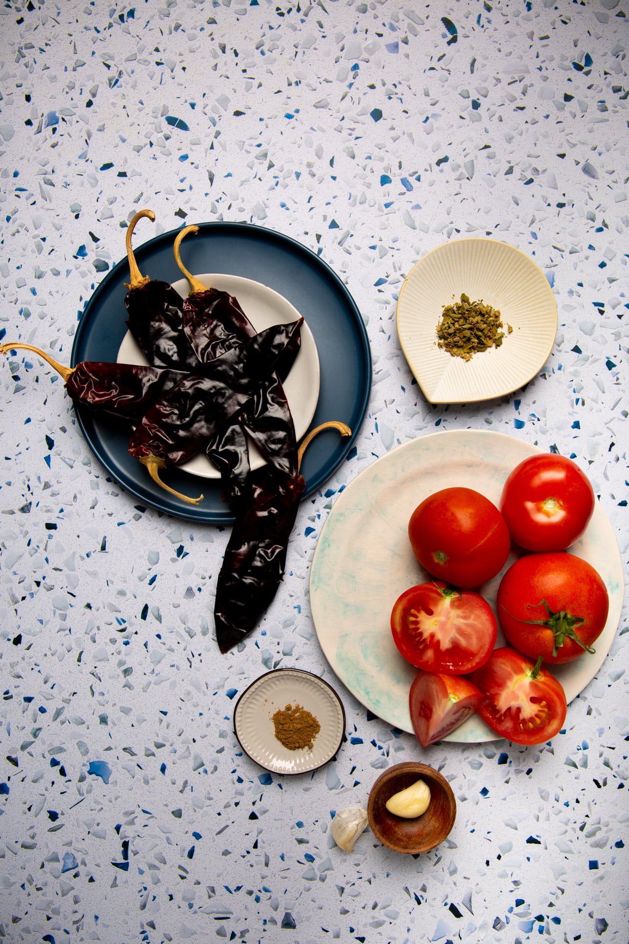 Close-up of vegan enchilada casserole showing layers of corn tortillas, smoky guajillo sauce, and sautéed vegetables