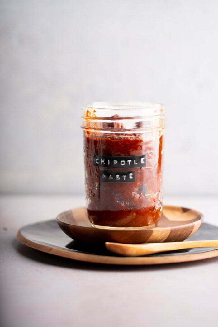 A jar with chipotle peppers in adobo sauce made into paste.