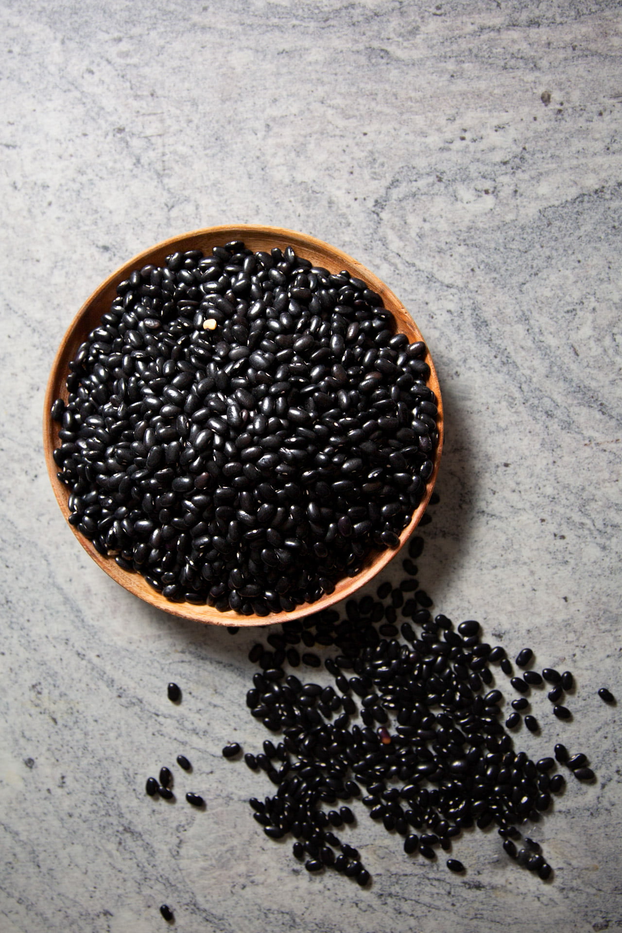 a wooden plate with black beans