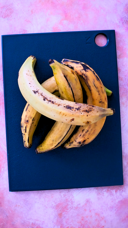 whole plantains over a blue cutting board