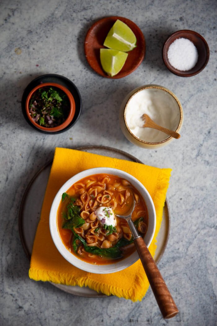 mexican vegan sopa de conchas in a white bowl and topping on the side