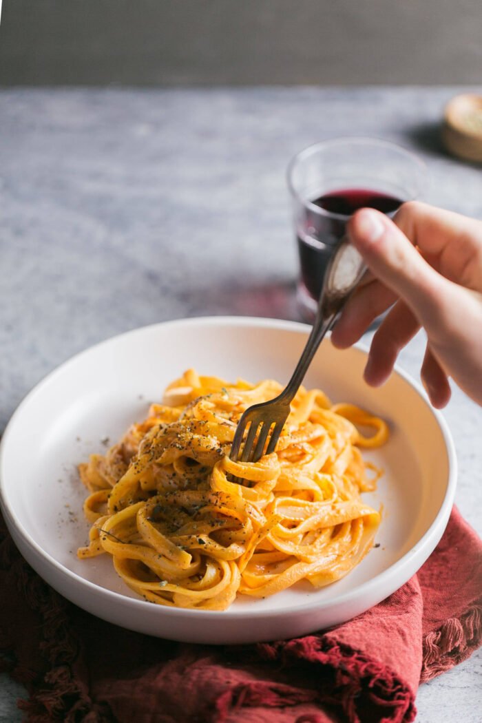 Twirling pasta with vegan vodka sauce on a fork.