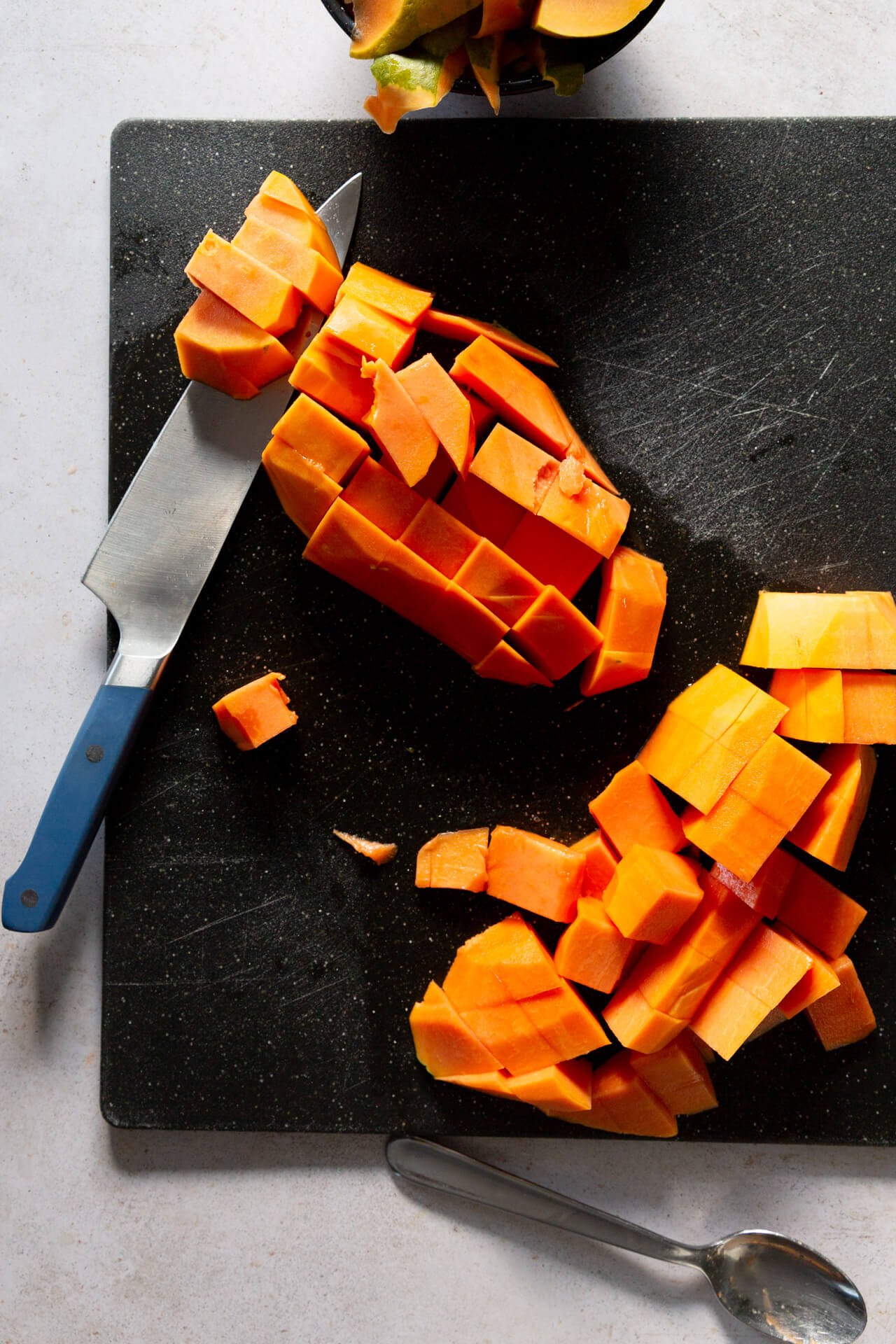 Diced papaya on a cutting board