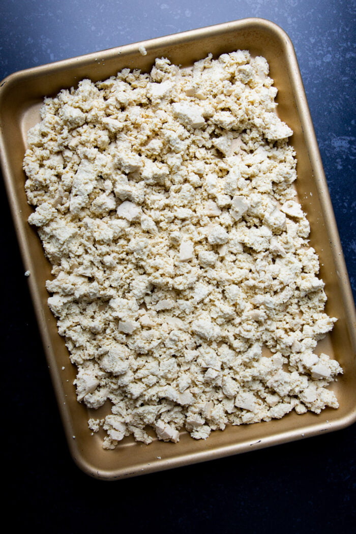 crumbled tofu on a golden brown platter