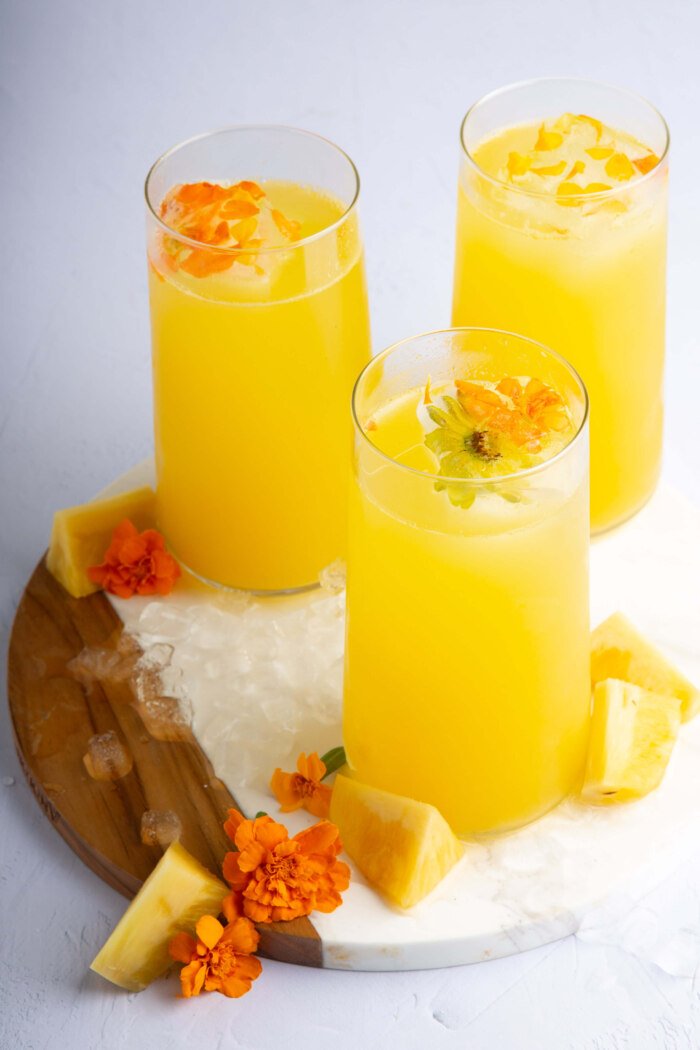 agua de piña served in three tall tumblers