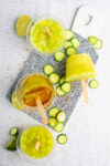 A tray of popsicles with limes and cucumbers, automatic eraser.