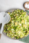 Brussels sprouts salad with avocado and salt.