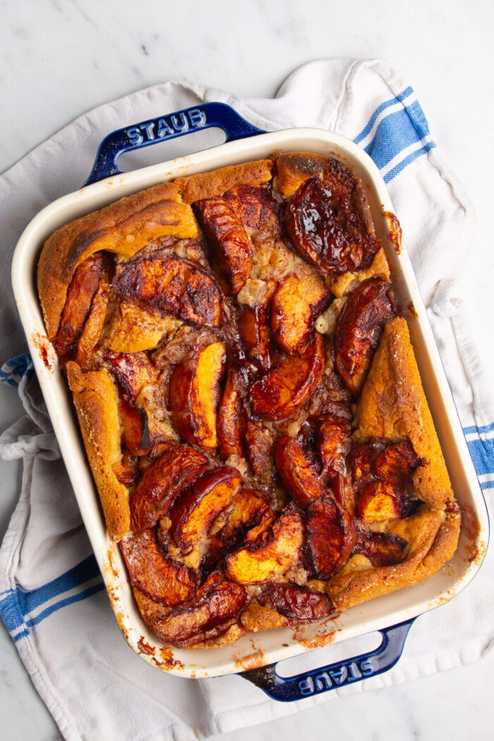 Homemade Peach Cobbler with peach bread pudding in a baking dish.