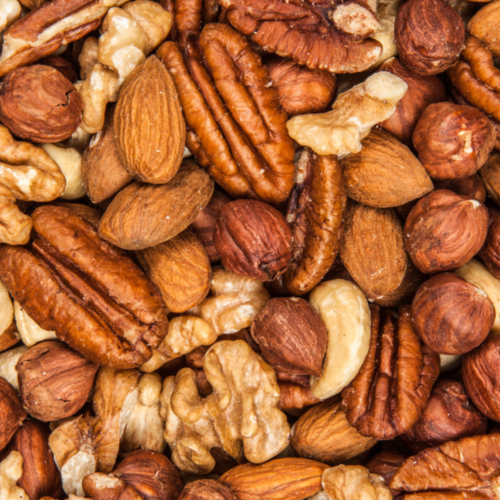 A close up image of a pile of nuts, a plant-based protein.