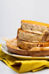 A vegan slice of spiced pumpkin bread is stacked on a plate.