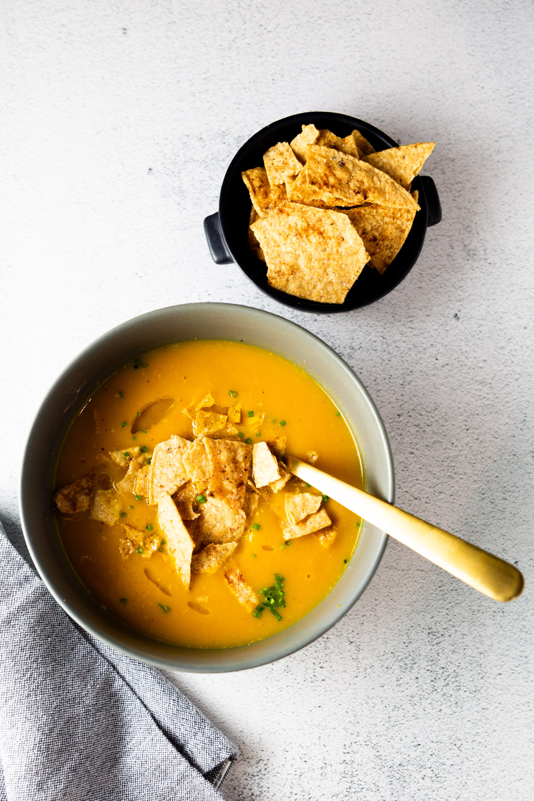 An easy Butternut Squash Soup recipe served with crispy tortilla chips.