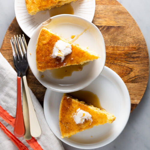 A slice of vegan cornbread on a plate with a fork.