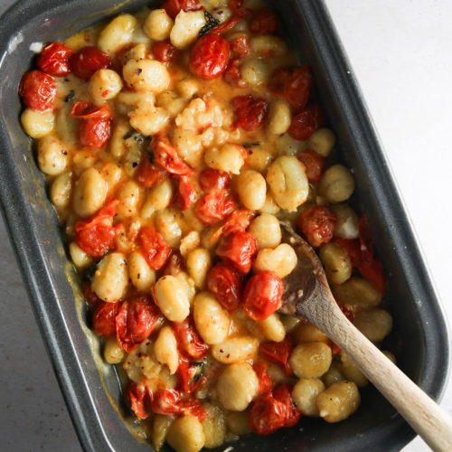 A baking dish filled with tomatoes and beans.