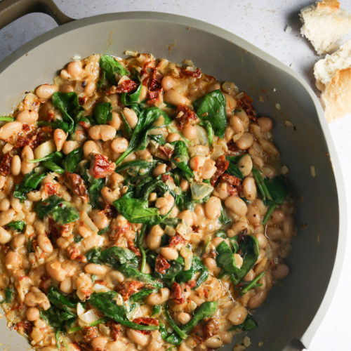 Marry me beans and spinach in a skillet.