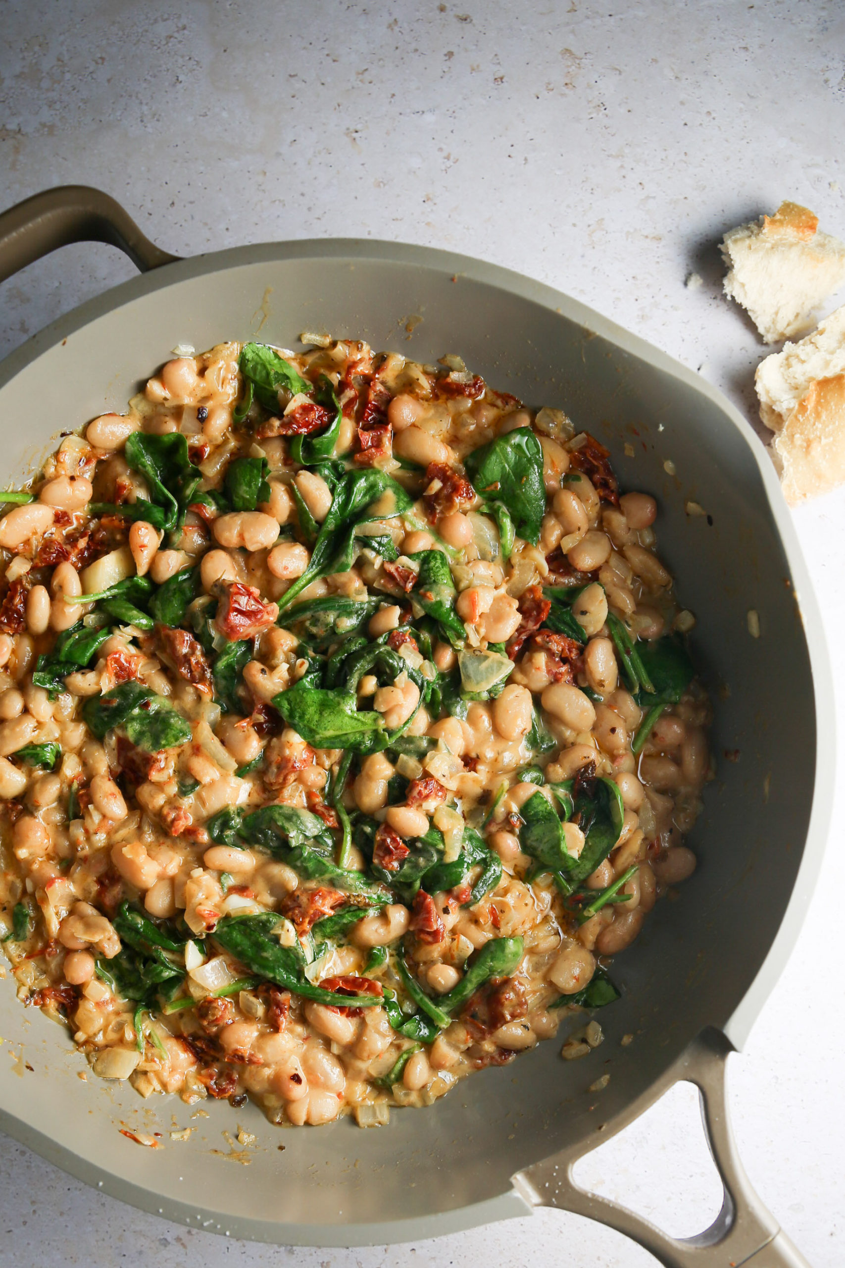         Marry me beans and spinach in a skillet.