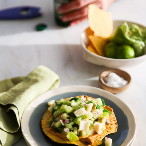 A plate of ceviche with hearts of palm on a table.