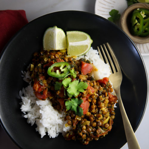 A plate of rice and lentils on an automatic table.