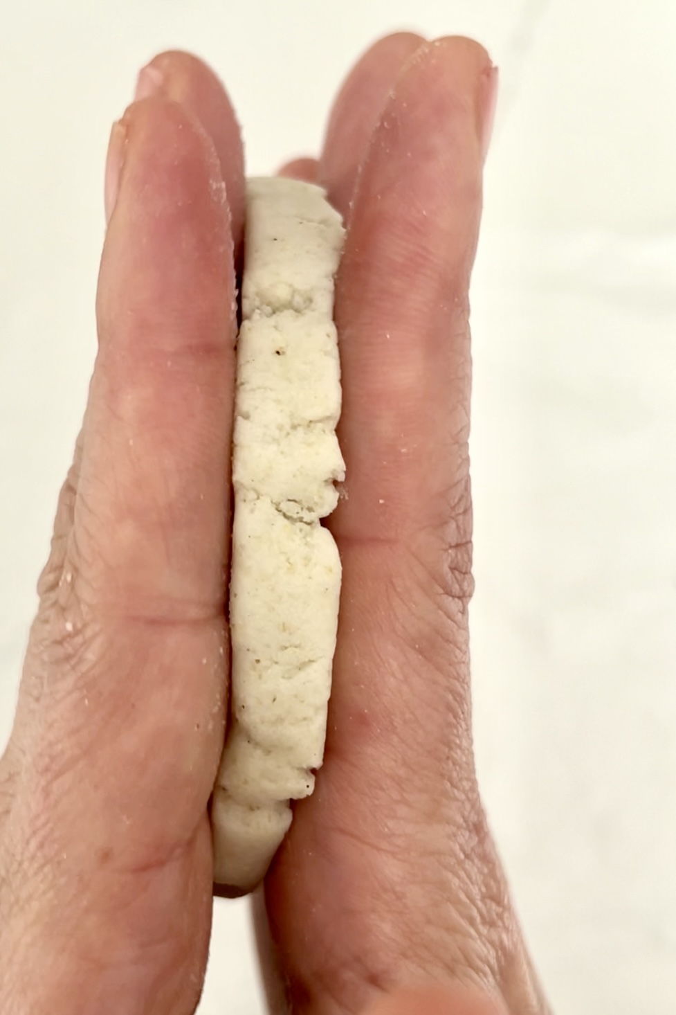 two hands with a raw sope in the middle