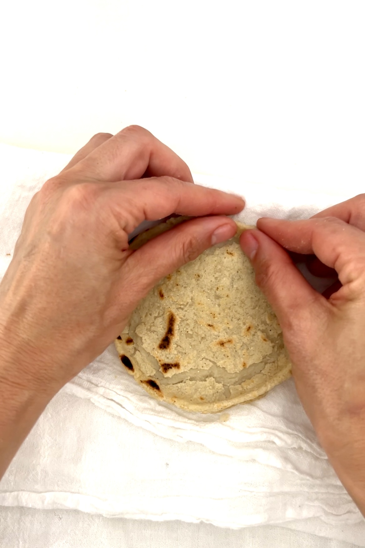 pinching the sope borderover a white kitchen towel
