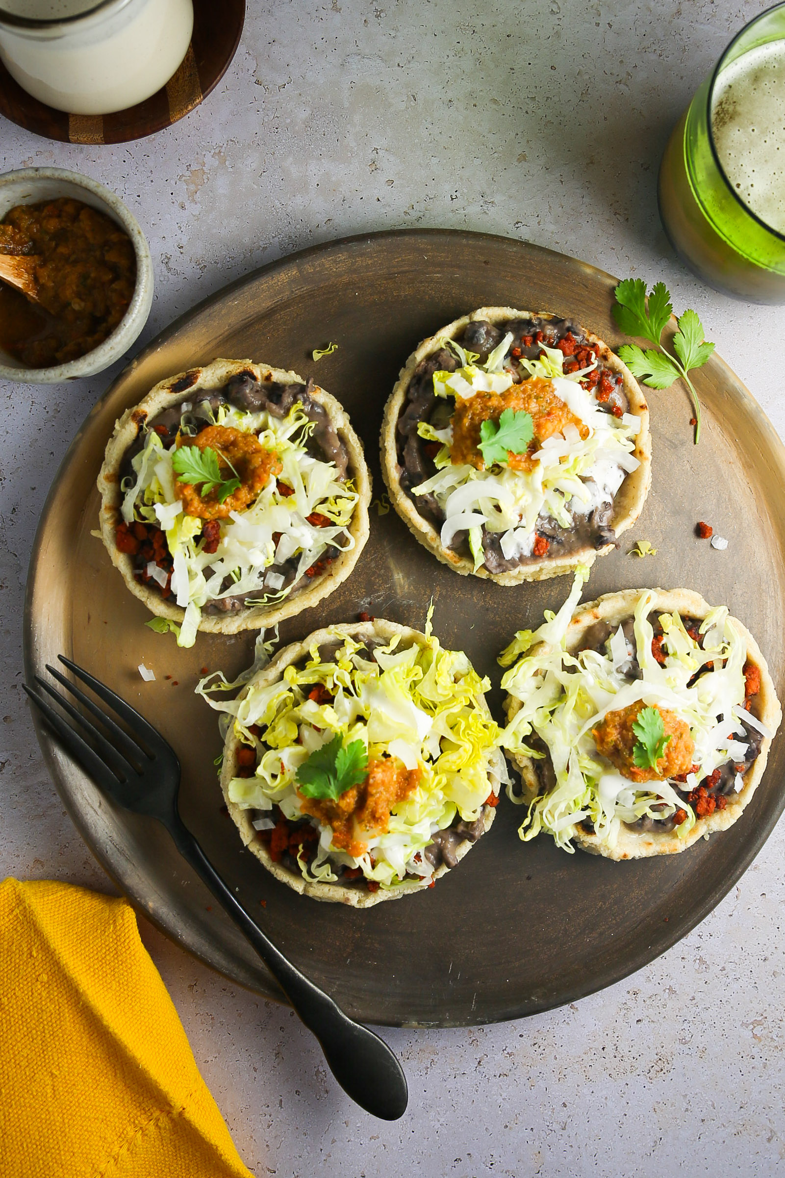 4 vegan mexican sopes on a clay dish